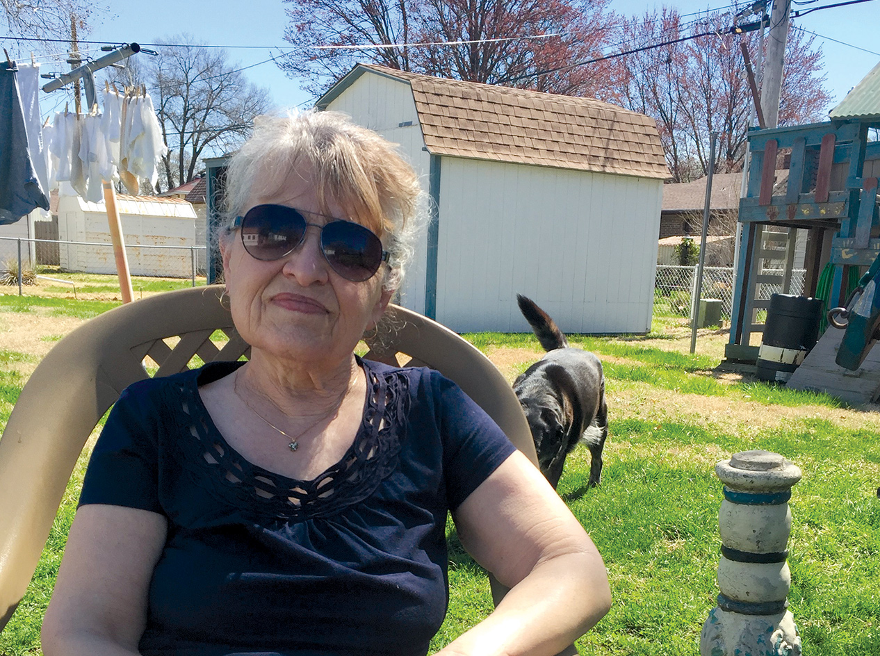 Linda Hager sitting outside at her home.