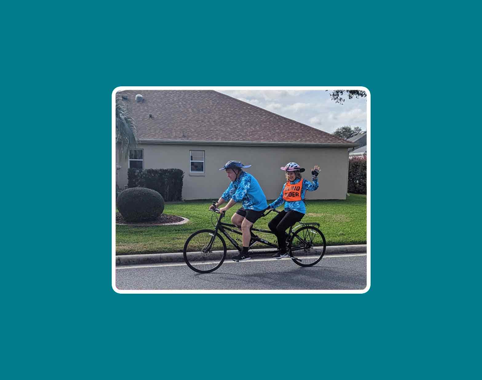 Carol Kitchen and her husband riding a tandem bicycle