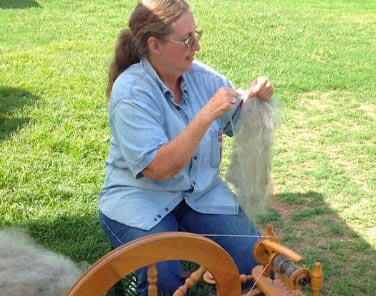 Celia Petersen at her spinning wheel