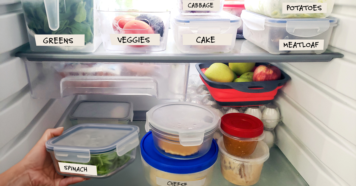 Inside a well-organized refrigerator, with containers and bins marked in large print.