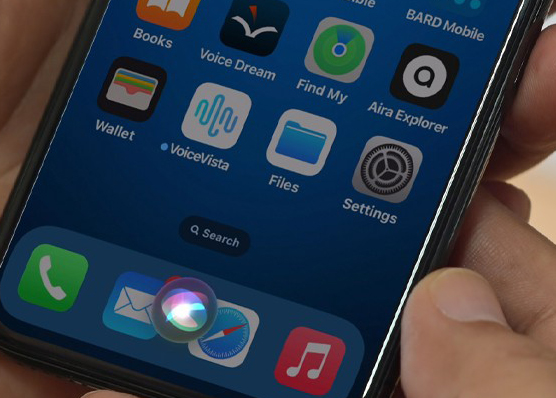 Hand holding smartphone with Siri activated