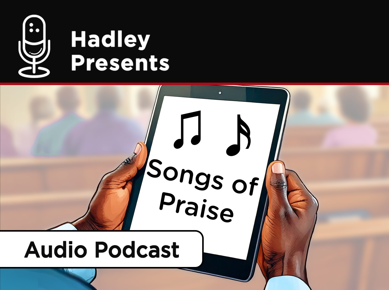 Close-up of older man's hands holding an iPad with the hymnal enlarged on the screen and parishioners in the pews in the background.