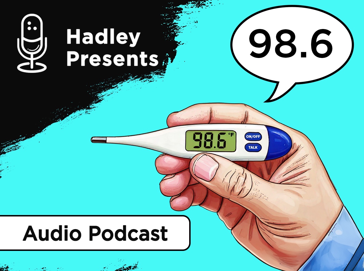 Close-up of a man's hand holding a talking thermometer showing 98.6 degrees on a large LCD display, with a talk bubble above showing 98.6.