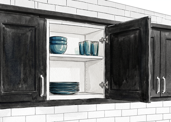Open kitchen cupboard door, showing plates and cups inside.