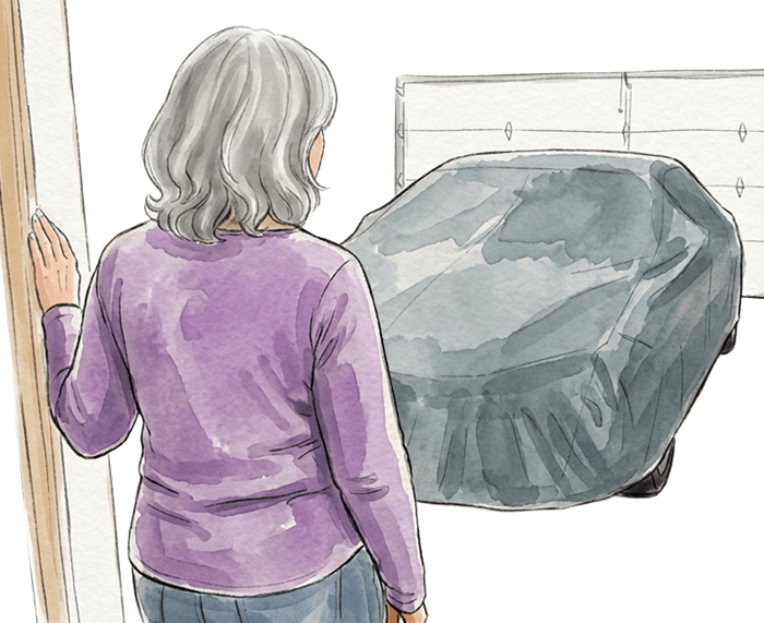 Person looking at the car in the garage